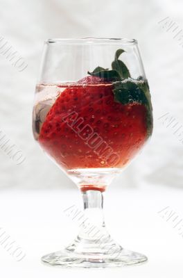 Strawberry in glass and ice