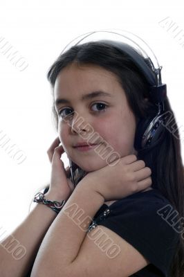 Young girl with headphones smiling at camera