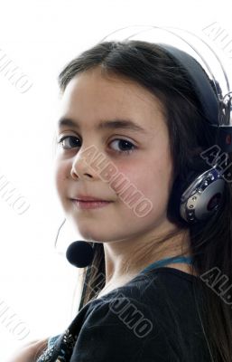 Young girl with headphones smiling at camera