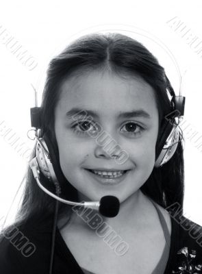 Young girl with headphones smiling at camera