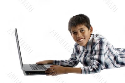 young boy doing homework on a laptop