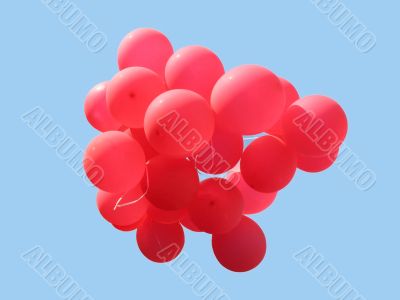 Bunch of red party balloons against blue sky