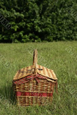 Picnic hamper basket in field