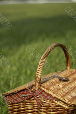 Picnic hamper basket in field