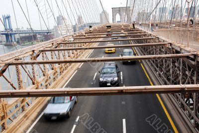 Traffic moving under Brooklyn bridge New York