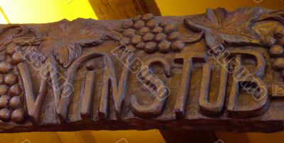 Wood sign of a winstub, winebar in Alsace