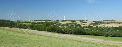 Panorama of windfarm over a hill