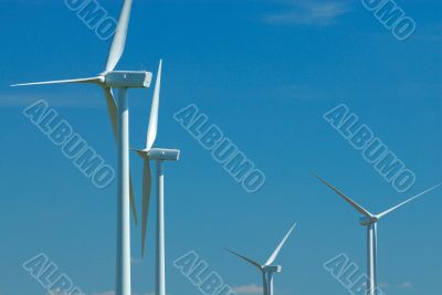 four windturbines on blue sky