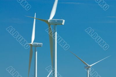 three windturbines on blue sky