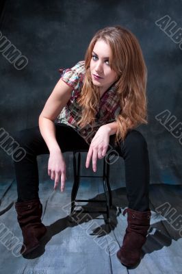 Dirty-blond sitting on stool