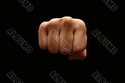 A manï¿½s fist isolated on black background