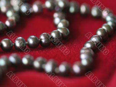 Black pearl necklace on red velvet2