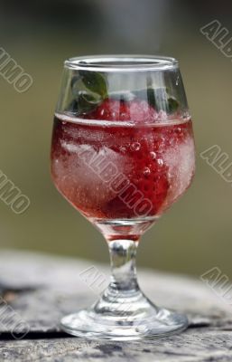 Strawberry in glass and ice