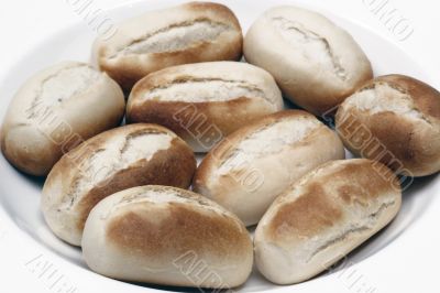 freshly baked white bread rolls on white