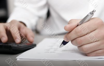 businessman calculating expenses at tax time