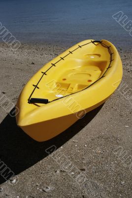 colorful kayaks on beach by turquoise waters