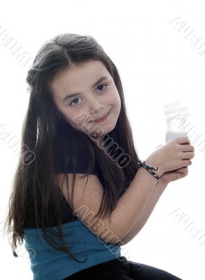 Young girl with an energy saver light globe