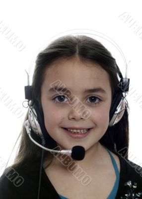 Young girl with headphones smiling at camera