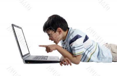 young boy doing homework on a laptop