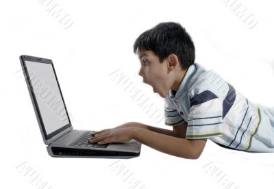 young boy doing homework on a laptop