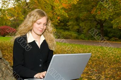 Woman with Laptop in Park.