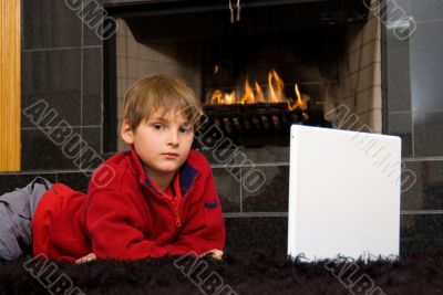 Boy at Fireplace on Computer