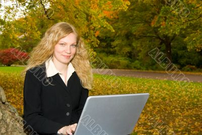 Woman with Laptop in Park.