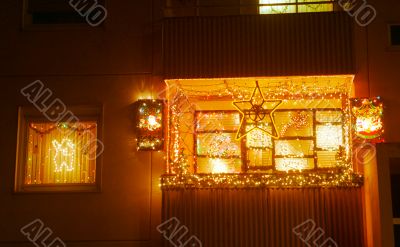 balcony and windows lighting up to Christmastime