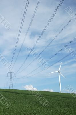 a windturbine close to a electric pylon