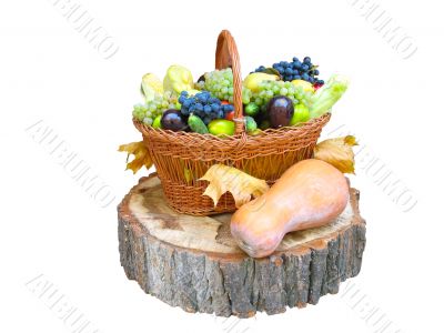 wooden basket with fruit and vegetables over a wooden bark isolated over white background