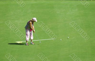 old woman playing golf