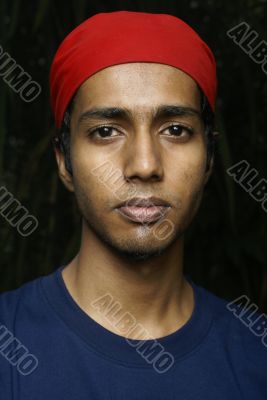 Young indian man with red scarf headwear