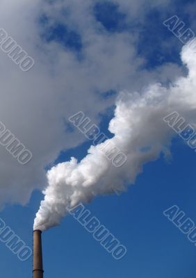 Smokes of a chimney on blue sky