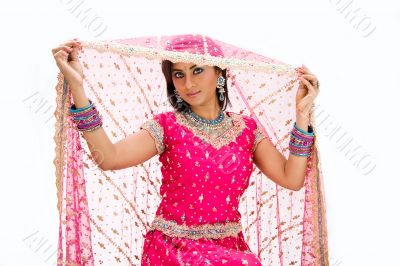 Beautiful Bangali bride lifting veil