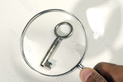 key under a magnifying glass