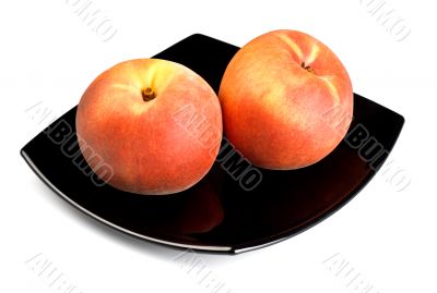 red peaches on black dish