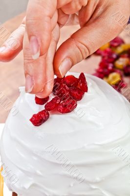 Hands decorating christmas cake