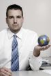 Businessman holding globe