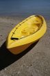 colorful kayaks on beach by turquoise waters