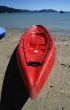 colorful kayaks on beach by turquoise waters