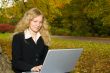 Woman with Laptop in Park.