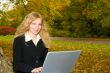 Woman with Laptop in Park.