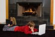 Boy at Fireplace on Computer.