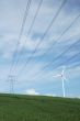 a windturbine close to a electric pylon