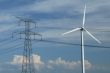 a windturbine close to a electric pylon