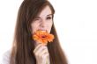 portrait of attractive girl eating flowers