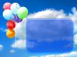 Colored party balloons against blue sky and empty place for your