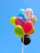 Bunch of colored party balloons against blue sky