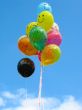 Bunch of colored party balloons against blue sky