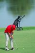 Golfer putting on green golf course